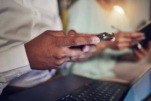 laptop-typing-and-hands-of-person-with-phone-for-2025-04-06-09-57-32-utc